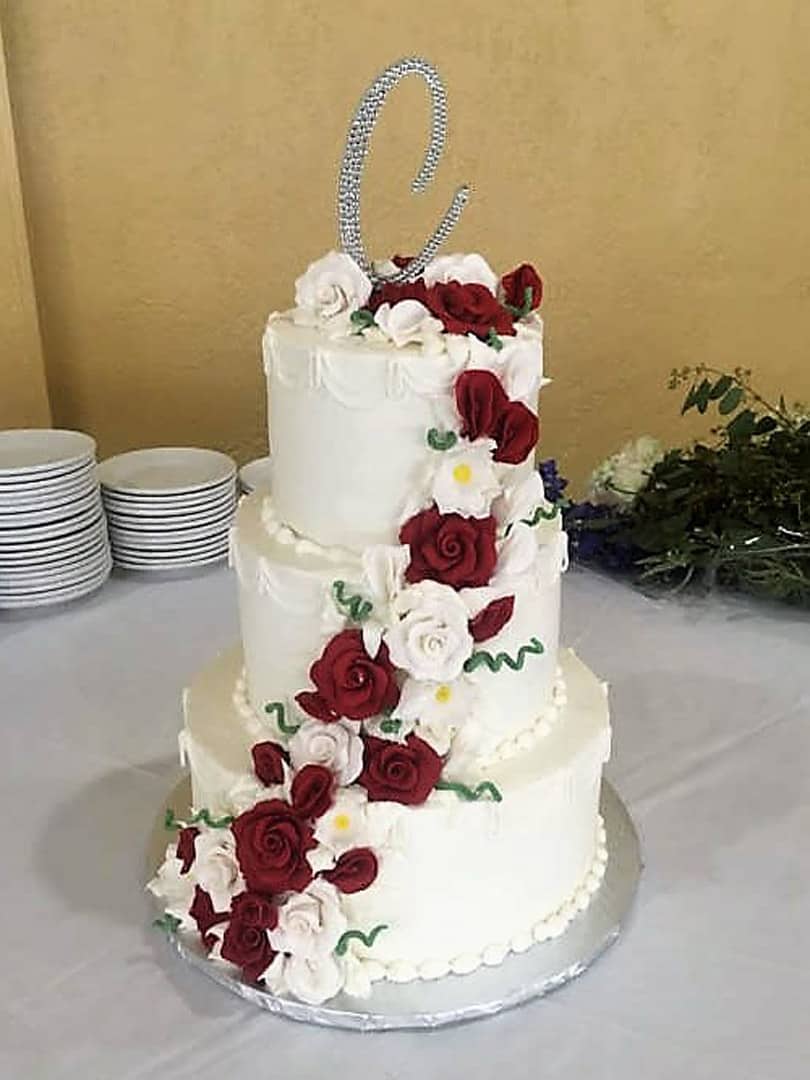 Wedding Cake With Red and White Flowers